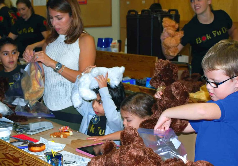 Children packing teddy bears